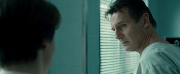 Movie still from “Unknown” (2011), directed by Jaume Collet-Serra – A man looking at himself in the mirror in front of a window; Close Up shot, Over the shoulder angle