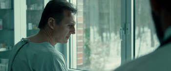 Movie still from “Unknown” (2011), directed by Jaume Collet-Serra – A person looking out of a window; Close Up shot, Low angle