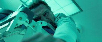 Movie still from “Unknown” (2011), directed by Jaume Collet-Serra – A man holding an electronic device in his hand; Close Up shot, Low angle