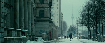 Movie still from “Unknown” (2011), directed by Jaume Collet-Serra – People walking down a snowy sidewalk in a city; Extreme Wide shot, Low angle