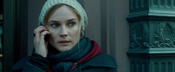 Movie still from “Unknown” (2011), directed by Jaume Collet-Serra – A person wearing a hat and a scarf; Close Up shot, Over the shoulder angle