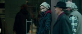 Movie still from “Unknown” (2011), directed by Jaume Collet-Serra – A young woman wearing a white hat and a black jacket; Close Up shot, Over the shoulder angle