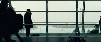 Movie still from “Unknown” (2011), directed by Jaume Collet-Serra – A woman standing in front of a window looking out; Wide shot, Low angle