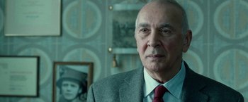 Movie still from “Unknown” (2011), directed by Jaume Collet-Serra – An older man wearing a suit and a red neck tie; Close Up shot, Over the shoulder angle