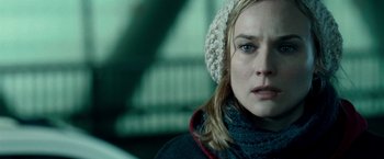 Movie still from “Unknown” (2011), directed by Jaume Collet-Serra – A person wearing a hat and a scarf; Close Up shot, Over the shoulder angle