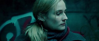 Movie still from “Unknown” (2011), directed by Jaume Collet-Serra – A person wearing ear cuffs; Close Up shot, Low angle