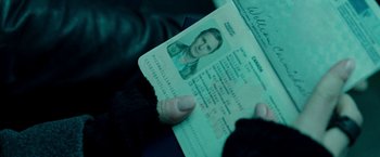 Movie still from “Unknown” (2011), directed by Jaume Collet-Serra – A person holding a passport in their hand; Extreme Close Up shot, High angle
