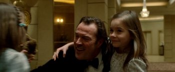 Movie still from “Unknown” (2011), directed by Jaume Collet-Serra – A man and a little girl posing for a picture; Close Up shot, Low angle