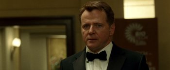 Movie still from “Unknown” (2011), directed by Jaume Collet-Serra – A person wearing a suit and a bow tie; Close Up shot, Over the shoulder angle