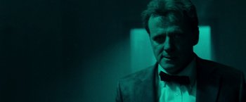 Movie still from “Unknown” (2011), directed by Jaume Collet-Serra – A man wearing a suit and bow tie; Close Up shot, Low angle