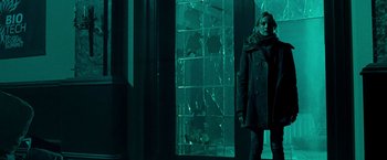 Movie still from “Unknown” (2011), directed by Jaume Collet-Serra – A woman standing in front of a broken glass window; Medium shot, Low angle