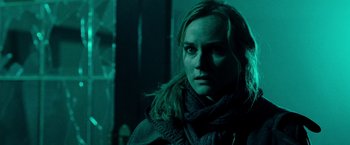 Movie still from “Unknown” (2011), directed by Jaume Collet-Serra – A person wearing a scarf in a dark room; Close Up shot, Low angle
