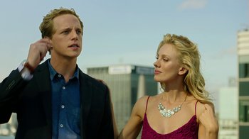 Movie still from “Urge” (2016), directed by Aaron Kaufman – A man and a woman standing next to each other; Close Up shot, Low angle