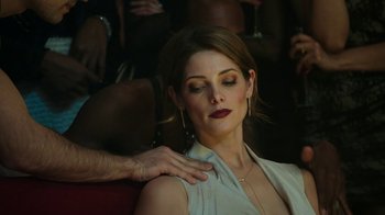 Movie still from “Urge” (2016), directed by Aaron Kaufman – A beautiful woman sitting in front of a group of people; Close Up shot, Over the shoulder angle