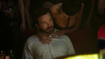 Movie still from “Urge” (2016), directed by Aaron Kaufman – A man and a woman sitting on a man's chest; Medium shot, Over the shoulder angle