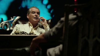 Movie still from “Urge” (2016), directed by Aaron Kaufman – A man sitting in front of another man smoking a cigarette; Medium shot, Over the shoulder angle