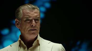 Movie still from “Urge” (2016), directed by Aaron Kaufman – An older man in a white shirt and jacket; Close Up shot, Low angle