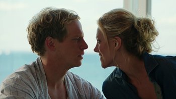 Movie still from “Urge” (2016), directed by Aaron Kaufman – A man and a woman face to face in front of a window; Close Up shot, Over the shoulder angle