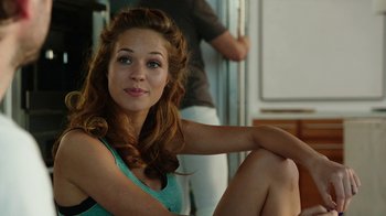 Movie still from “Urge” (2016), directed by Aaron Kaufman – A beautiful young woman sitting on the ground; Close Up shot, Over the shoulder angle