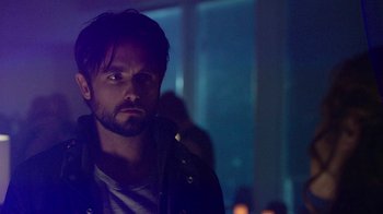 Movie still from “Urge” (2016), directed by Aaron Kaufman – A person wearing a jacket; Close Up shot, Over the shoulder angle