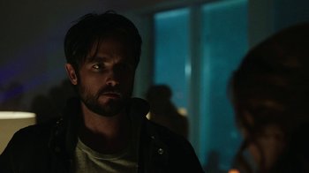 Movie still from “Urge” (2016), directed by Aaron Kaufman – A person wearing a jacket; Close Up shot, Over the shoulder angle