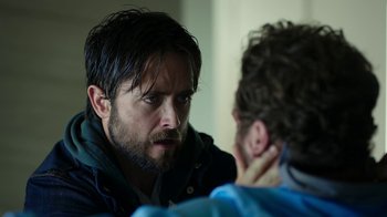 Movie still from “Urge” (2016), directed by Aaron Kaufman – A man looking at himself in the mirror; Close Up shot, Over the shoulder angle