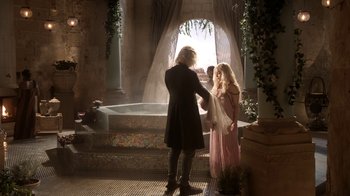 Movie still from “Game of Thrones” (2011), created by D.B. Weiss – A man and a woman standing in front of a bath tub; Wide shot, Over the shoulder angle