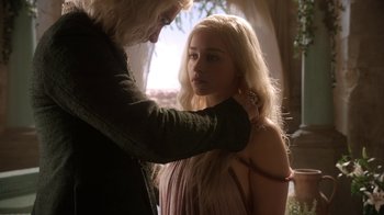 Movie still from “Game of Thrones” (2011), created by D.B. Weiss – A blonde woman is getting her hair combed by an older man; Close Up shot, Over the shoulder angle