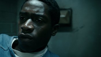 Movie still from “Snowfall” (2017), directed by Hiro Murai – A man's face in a dark room; Close Up shot, High angle