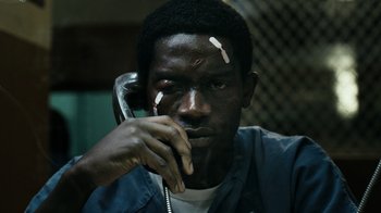 Movie still from “Snowfall” (2017), directed by Hiro Murai – A man holding a phone up to his ear; Close Up shot, High angle