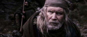 Movie still from “Valhalla Rising” (2009), directed by Nicolas Winding Refn – An old man with long grey hair and a long beard; Close Up shot, Low angle