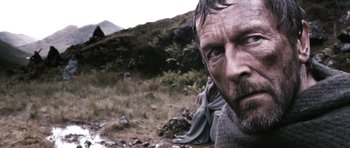 Movie still from “Valhalla Rising” (2009), directed by Nicolas Winding Refn – A man's face in the wilderness; Close Up shot, Low angle