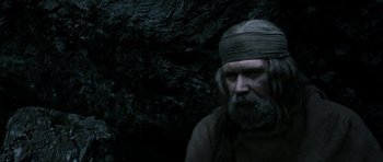 Movie still from “Valhalla Rising” (2009), directed by Nicolas Winding Refn – A man with long grey hair and a bandage around his head; Close Up shot, Low angle