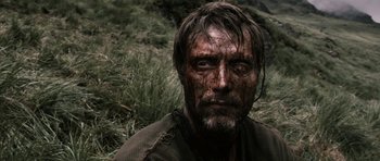 Movie still from “Valhalla Rising” (2009), directed by Nicolas Winding Refn – A person wearing a shirt; Close Up shot, Low angle