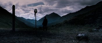 Movie still from “Valhalla Rising” (2009), directed by Nicolas Winding Refn – A man standing in the middle of a grassy field; Extreme Wide shot, Low angle