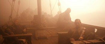Movie still from “Valhalla Rising” (2009), directed by Nicolas Winding Refn – Two men sitting on a boat in the fog; Wide shot, High angle