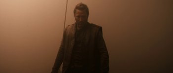 Movie still from “Valhalla Rising” (2009), directed by Nicolas Winding Refn – A man standing in a room wearing a leather jacket; Medium shot, Low angle