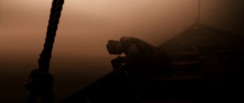Movie still from “Valhalla Rising” (2009), directed by Nicolas Winding Refn – A man sitting on a bench in the fog; Wide shot, Low angle