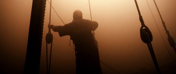 Movie still from “Valhalla Rising” (2009), directed by Nicolas Winding Refn – A man standing on a rope in the fog; Wide shot, Low angle