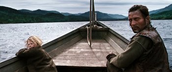 Movie still from “Valhalla Rising” (2009), directed by Nicolas Winding Refn – A person sitting in a boat on the water; Wide shot, Low angle