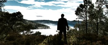 Movie still from “Valhalla Rising” (2009), directed by Nicolas Winding Refn – A man standing on top of a hill looking out at a body of water; Extreme Wide shot, Low angle