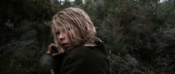 Movie still from “Valhalla Rising” (2009), directed by Nicolas Winding Refn – A young person with long blonde hair holding a camera; Close Up shot, High angle