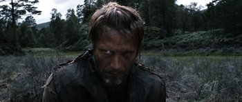 Movie still from “Valhalla Rising” (2009), directed by Nicolas Winding Refn – A person with a beard; Close Up shot, Over the shoulder angle
