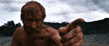 Movie still from “Valhalla Rising” (2009), directed by Nicolas Winding Refn – A person with dirt all over his face; Extreme Close Up shot, Low angle