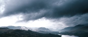 Movie still from “Valhalla Rising” (2009), directed by Nicolas Winding Refn – A cloudy sky over a valley with mountains in the background; Extreme Wide shot, Low angle