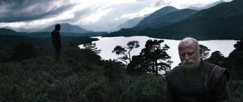 Movie still from “Valhalla Rising” (2009), directed by Nicolas Winding Refn – A body of water surrounded by trees and mountains; Extreme Wide shot, Low angle
