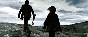 Movie still from “Valhalla Rising” (2009), directed by Nicolas Winding Refn – A man and a woman walking across a rocky hill; Medium shot, Low angle
