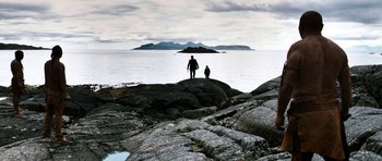 Movie still from “Valhalla Rising” (2009), directed by Nicolas Winding Refn – Two people standing on a rock formation near the ocean; Extreme Wide shot, High angle