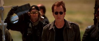 Movie still from “Vampires” (1998), directed by John Carpenter – A man wearing sunglasses and a leather jacket; Close Up shot, Low angle