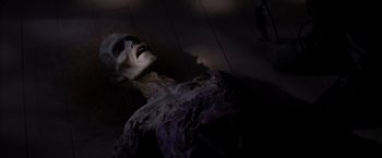Movie still from “Vampires” (1998), directed by John Carpenter – A skeleton is laying on the ground in a dark room; Close Up shot, High angle